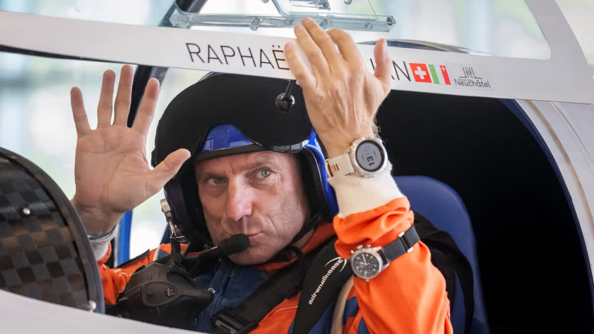 Swiss pilot Raphael Domjan waves prior to taking off in his first attempt of the season at setting a new aviation record by reaching an altitude of 10,000 metres onboard the solar-powered plane SolarStratos at the Sion airport, in Sion, southwestern Swizterland on August 8, 2025.