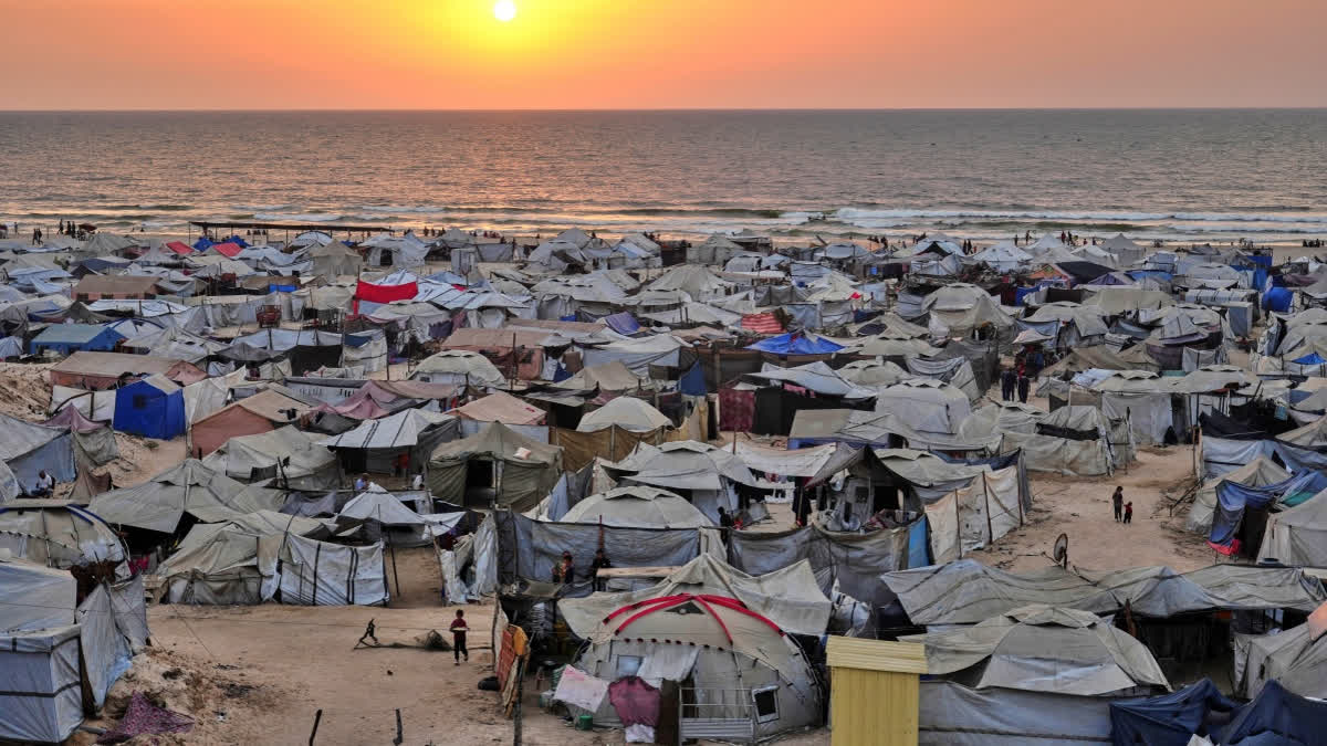Tents housing displaced Palestinians crowd the beach in Gaza City, as the sun sets over the Mediterranean Sea, Sunday, Aug. 10, 2025.