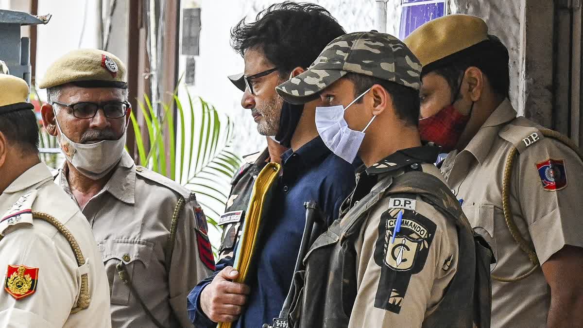 Police and security personnel escort pro-independence party Jammu Kashmir Liberation Front chairman Yasin Malik (3R) to a sentencing hearing at Patiala house court in New Delhi on May 25, 2022.
