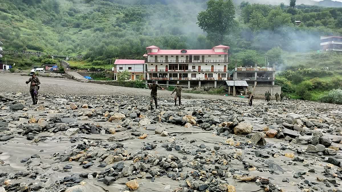 Security forces build a makeshift bridge across a river after flash flood at Dharali in Uttarkashi, Uttarakhand