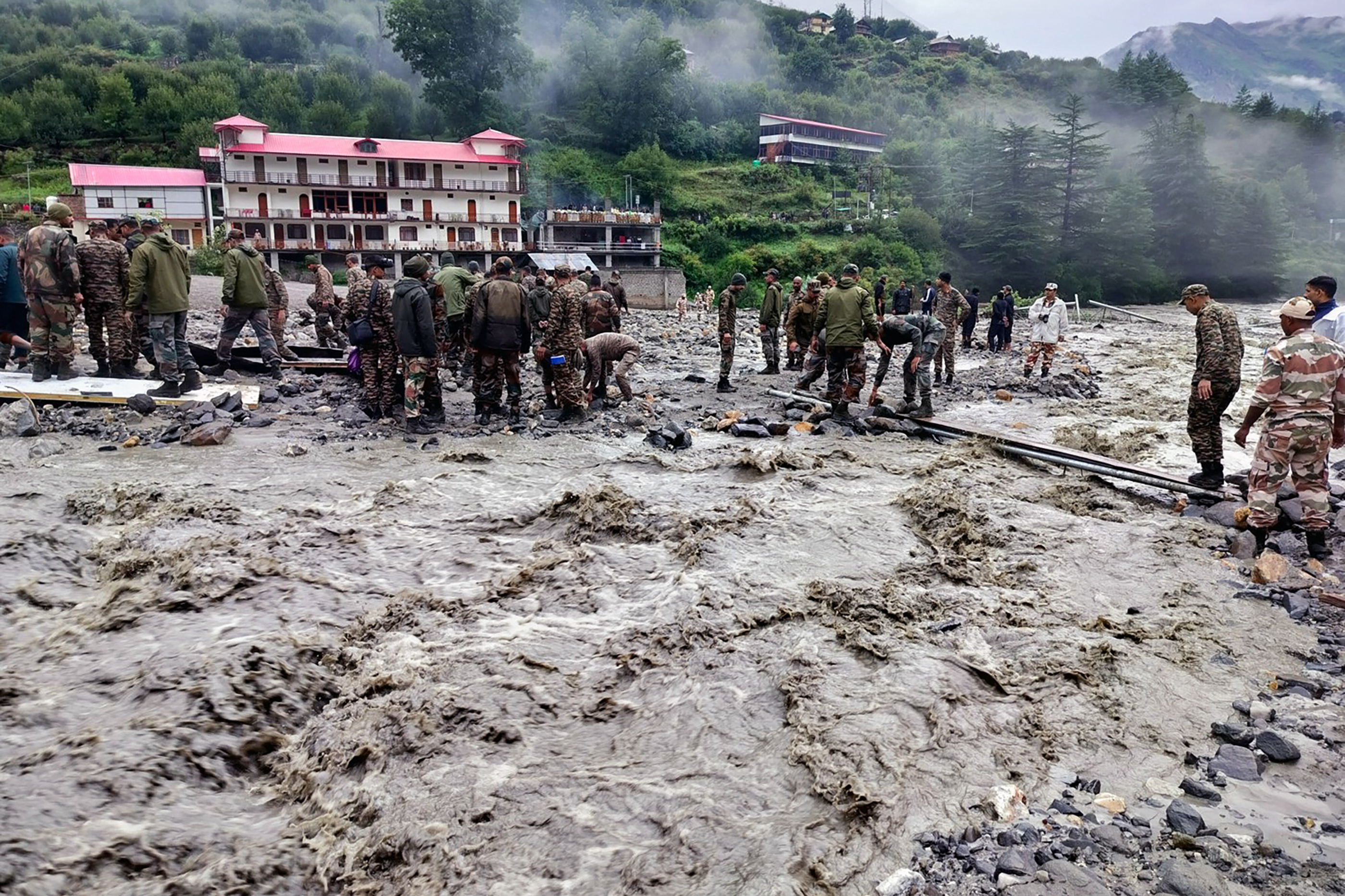 Security forces build a makeshift bridge across a river after flash flood at Dharali in Uttarkashi, Uttarakhand