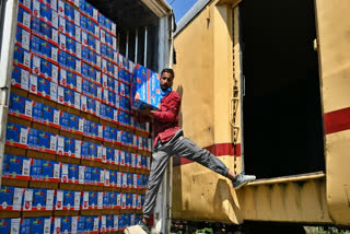 A worker loading apples in the first parcel train from Kashmir to Delhi at Budgam station in J&K on Thursday, Sept 11 2025.