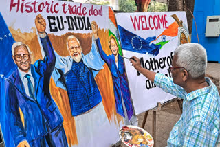 FILE - A teacher from Gurukul School of Art creating an artwork welcoming the the proposed India-EU Free Trade Agreement, in Mumbai.