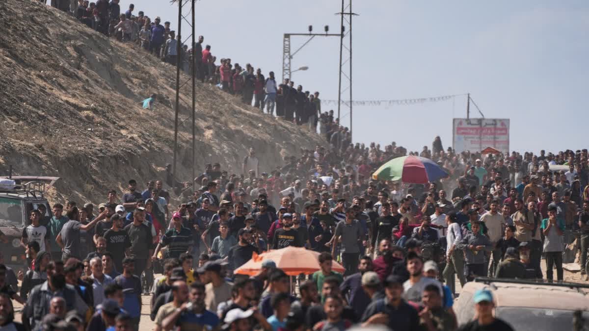 Displaced Palestinians walk along the coastal road near Wadi Gaza in the central Gaza Strip, moving toward northern Gaza, Friday, Oct. 10, 2025