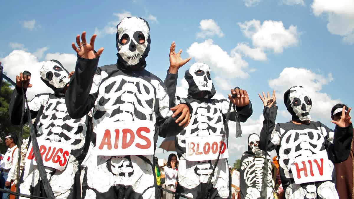 Activists dressed in skeleton costumes participate in an awareness rally to mark World AIDS Day in Agartala
