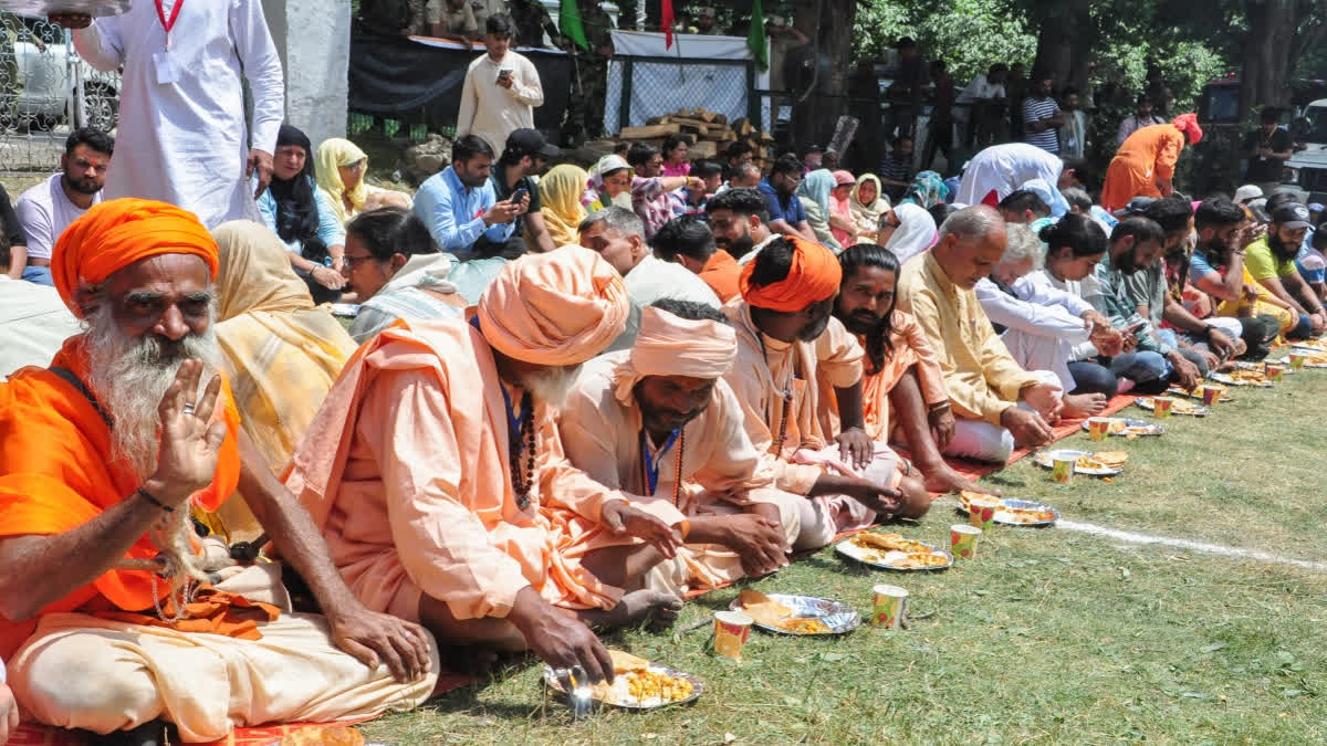 Amarnath Yatra Suspended On Baltal Route In Kashmir After Heavy Rains Devotees from the Amarnath Yatra eat langar organized by the head priest of the Chhari Mubarak custodian Mahant Deependra Giri, in Pahalgam on July 22.