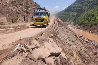 A bus moves on a damaged stretch of the Srinagar-Jammu National Highway 44 in Udhampur