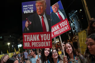 Holding up signs with images depicting the U.S. President Donald Trump people take part in a rally in support of hostages kidnapped by Hamas, at a plaza known as hostages square, in Tel Aviv, Israel, Saturday, Oct. 11, 2025.