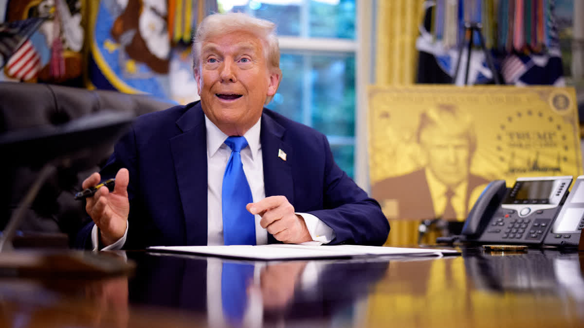President Donald Trump reacts to a question from a reporter before signing the H-1B and Gold Card executive orders.