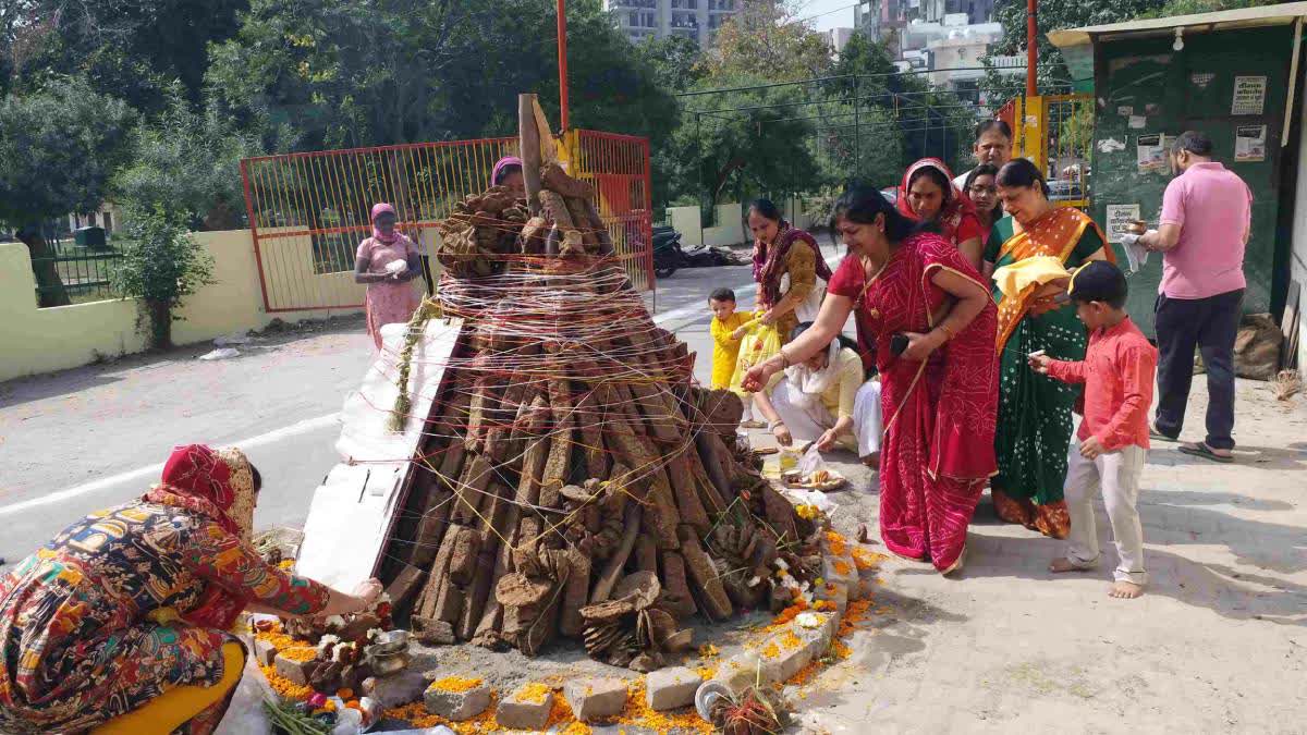 Women prepare a Holika with cow dung cakes.