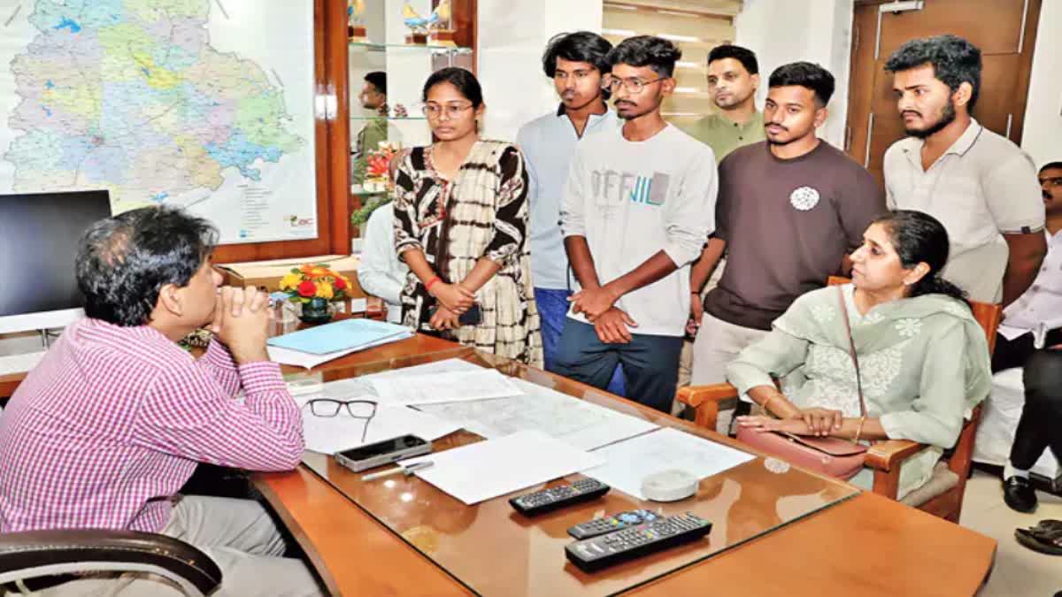 Students speak with Telangana Bhawan resident commissioner Gaurav Uppal in New Delhi on Monday.