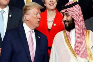 President Donald Trump, left, speaks with Saudi Arabia's Crown Prince Mohammed bin Salman during family photo session at G-20 leaders summit in Osaka, Japan, June 28, 2019.