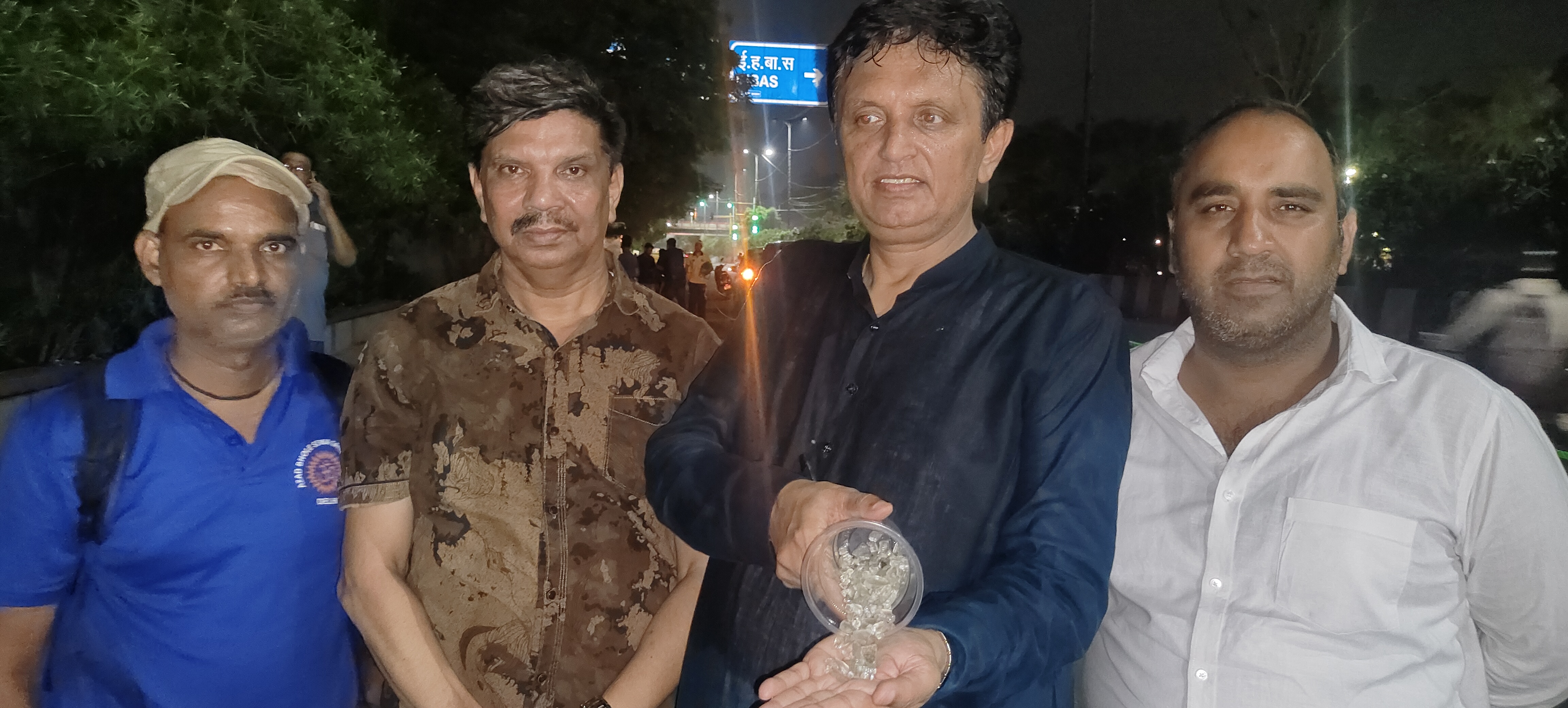 MLA Sanjay Goyal shows the glass pieces.