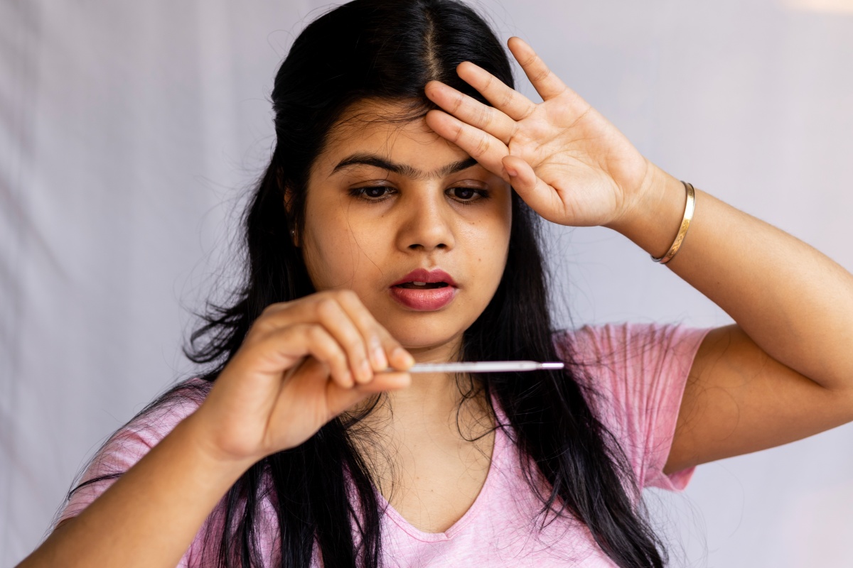 Girl checking her temperature