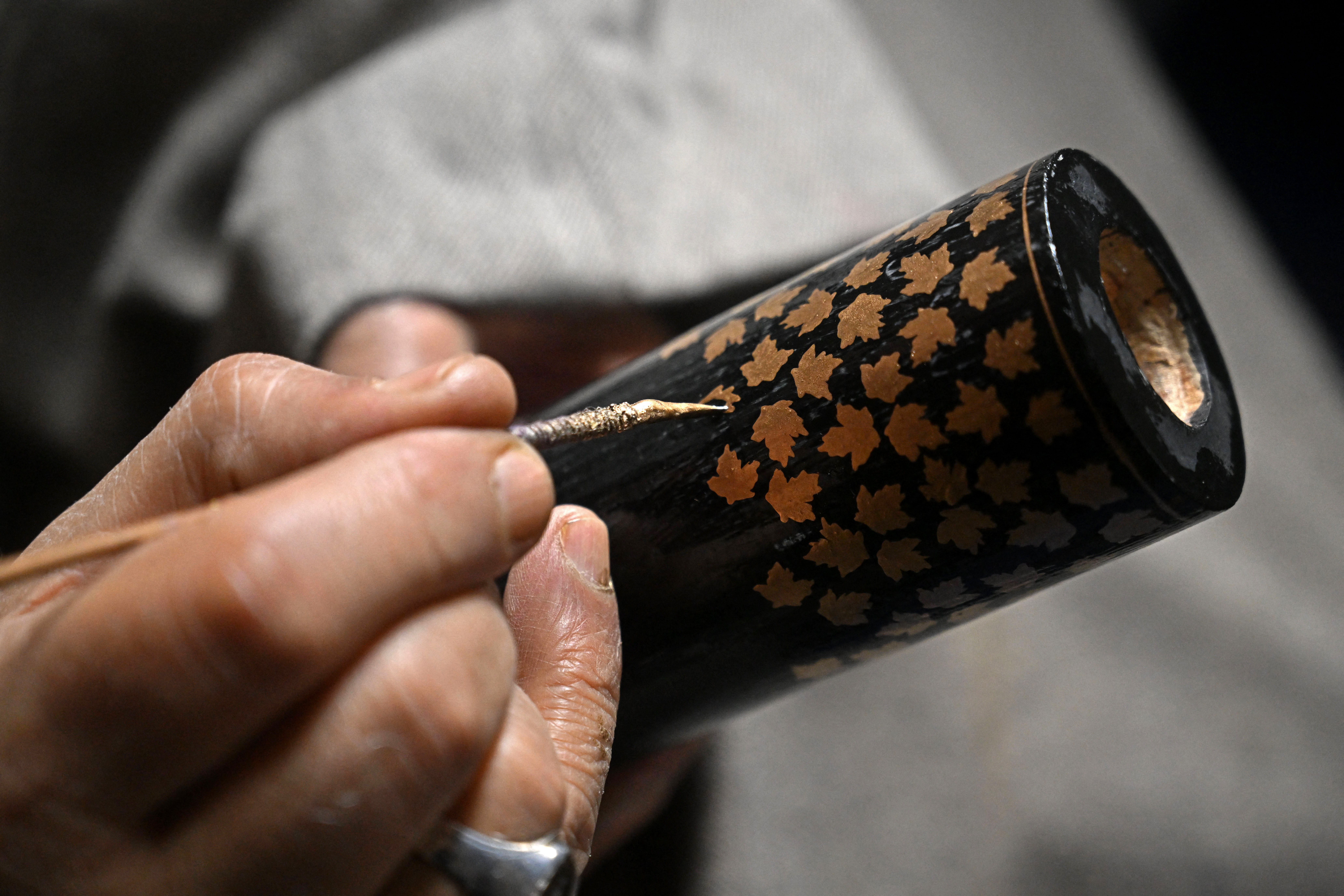 A Kashmiri artisan paints the finishing touches of a papier-mâché craft in Srinagar