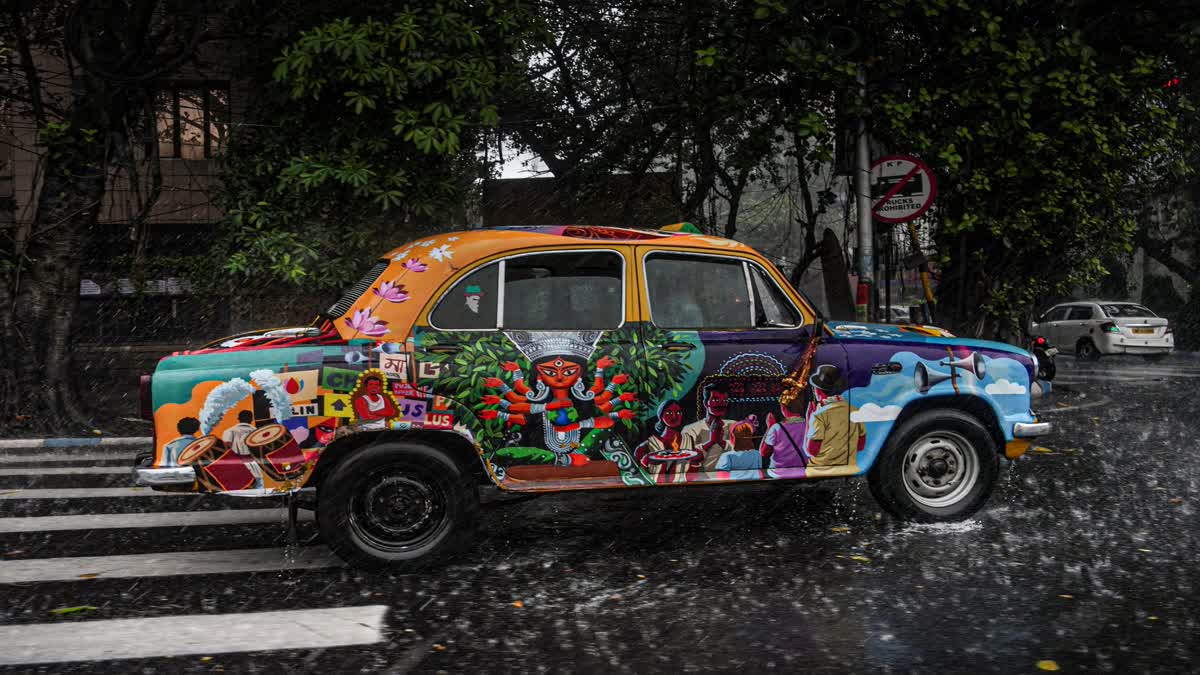 a Yellow taxi on kolkata road during Durga Puja