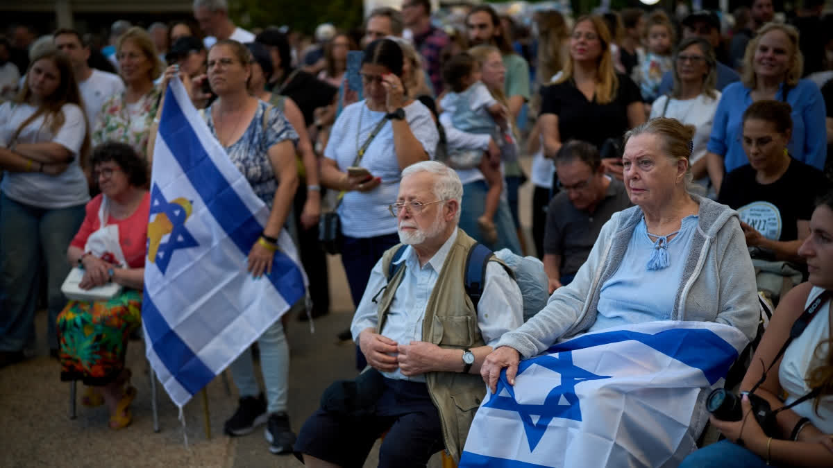 What To Know As Israel And Gaza Await The Release Of Hostages, Prisoners Attendees listen to a concert at a plaza known as hostages square, in Tel Aviv, Israel, Sunday, Oct. 12, 2025.