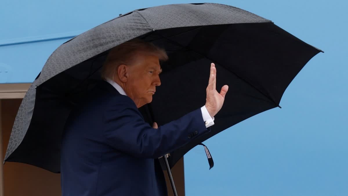 President Donald Trump waves from the stairs of Air Force One as he boards upon his arrival at Joint Base Andrews, Md., Sunday, Oct. 12, 2025, as he travels to the Middle East