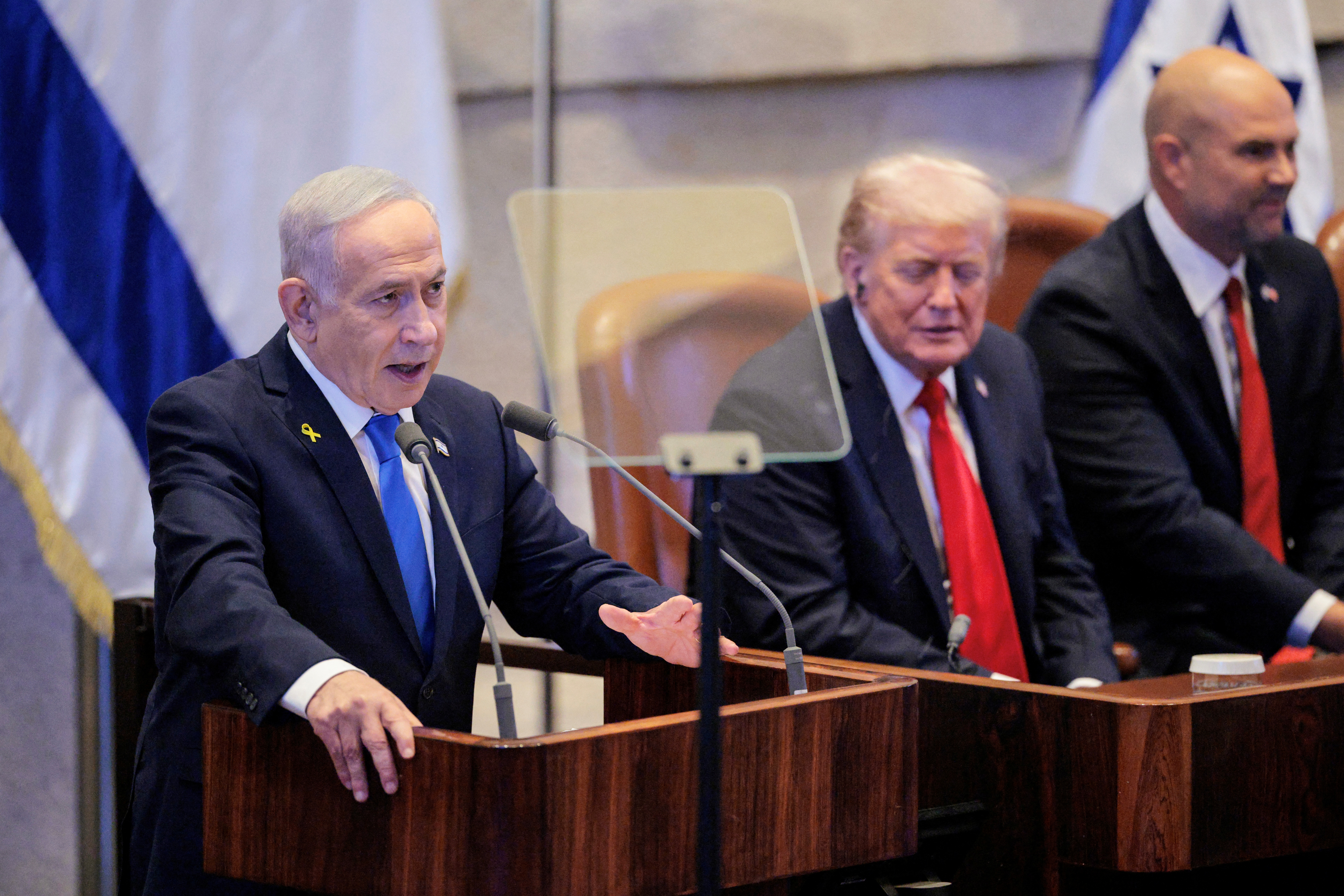 Israeli Prime Minister Benjamin Netanyahu (L) speaks as US President Donald Trump and Speaker of the Israeli Knesset Amir Ohana listen during an address to the Israeli parliament, the Knesset, in Jerusalem on October 13, 2025.