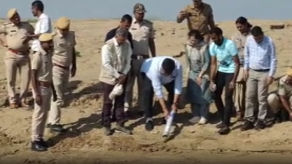 Forest Minister and others releasing gharials into river