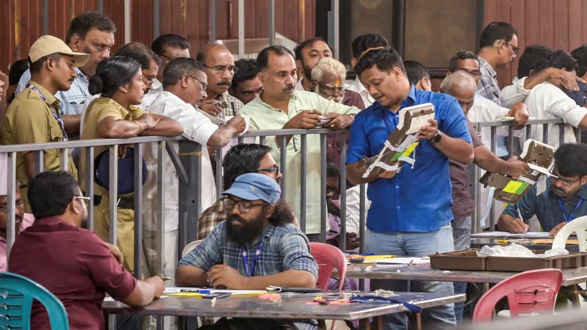 Political party workers watch the counting of votes for the Kerala local body elections in Thiruvananthapuram on Saturday.