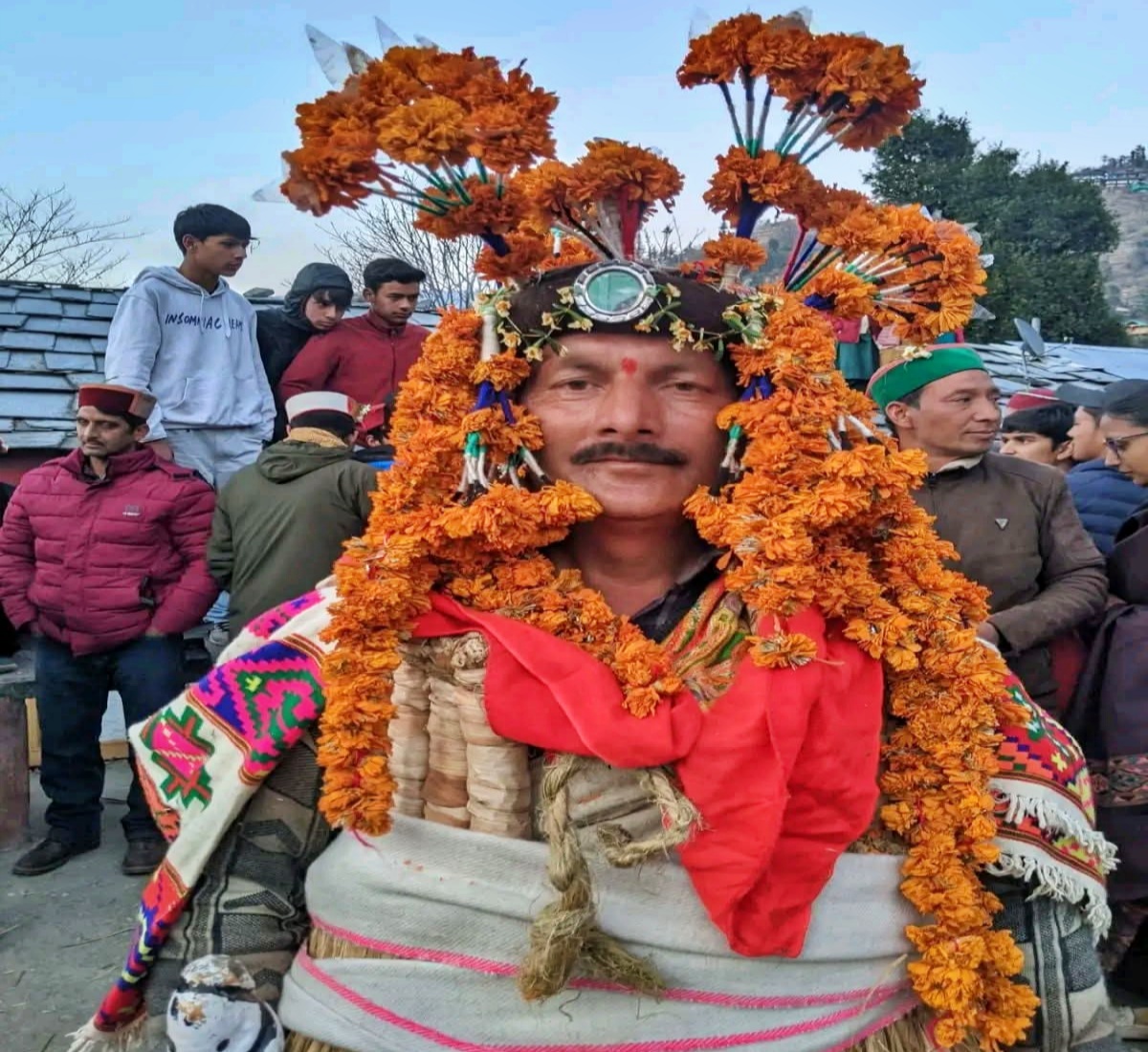A man wears a floral attire on Fagli festival in Kullu