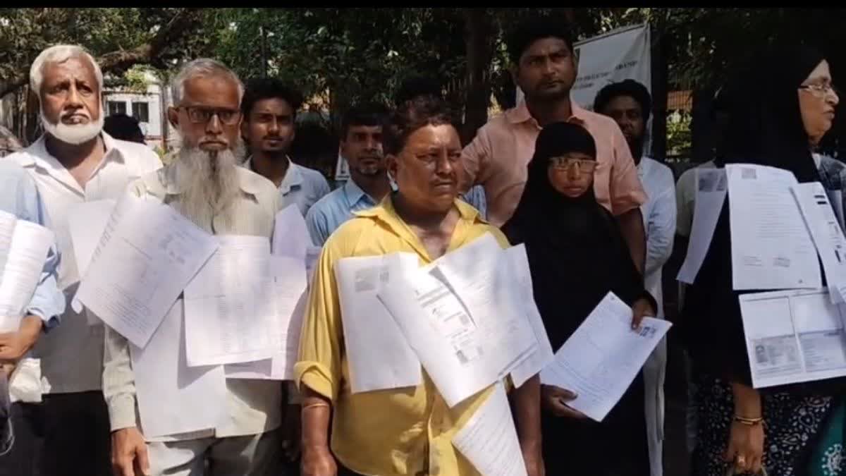 Protesters with documents in front of Arambagh SDO office on Monday