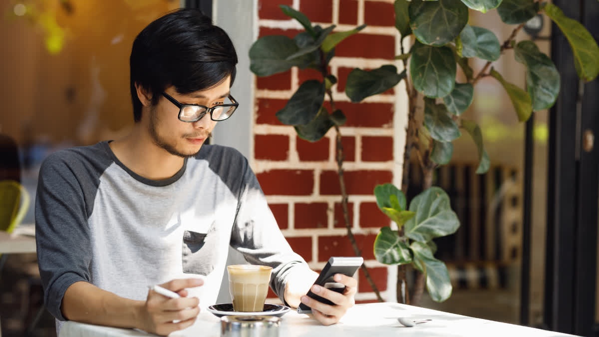 Man smoking while drinking coffee