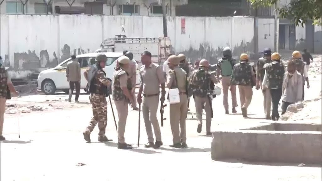 Police personnel in Noida as workers’ protest turns violent.