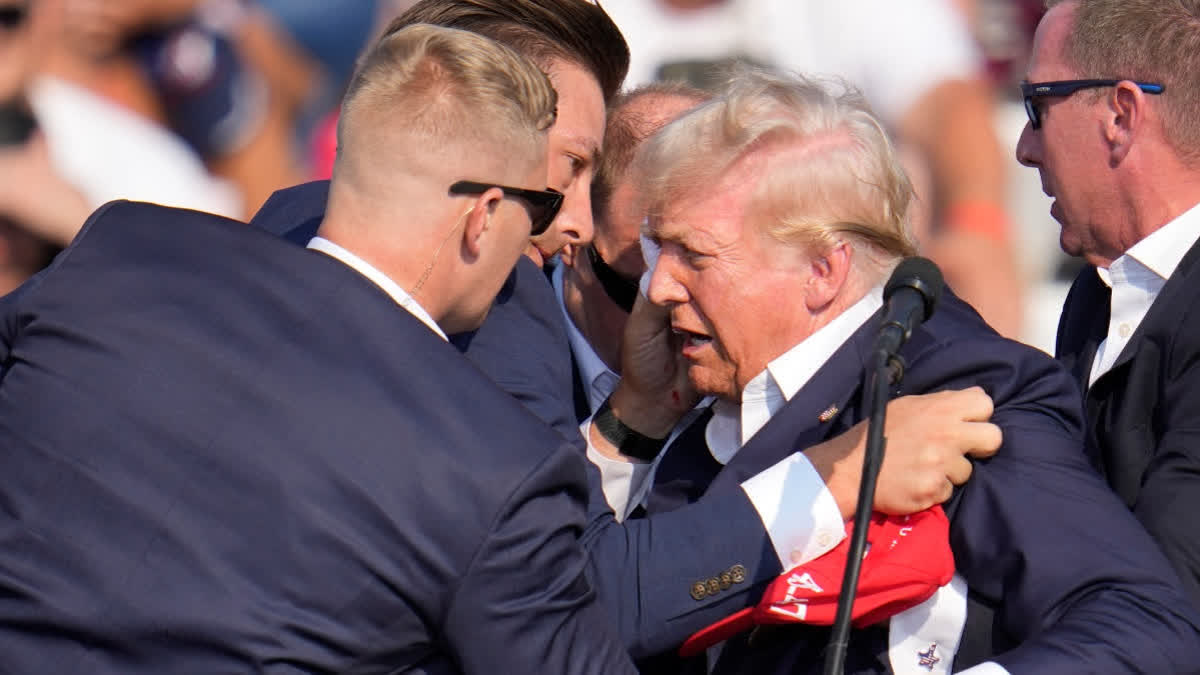 Shooting At Trump Rally: Chaos, Death And Recovery In A Matter Of Seconds Former US President Donald Trump surround by US Secret Service agents at campaign rally on July 13 in Butler, Pa.