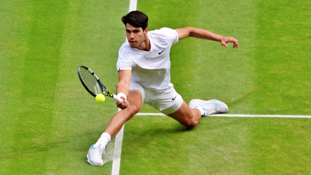 Carlos Alcaraz of Spain returns the ball to Novak Djokovic of Serbia during the men's singles final at the Wimbledon tennis championships in, Sunday, July 14, 2024.