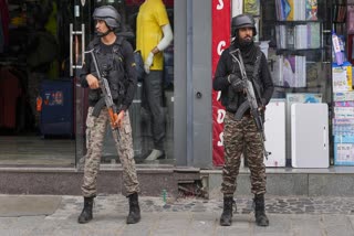 Security personnel stand guard on a road on the eve of Independence Day, in Srinagar, Thursday, Aug. 14, 2025.