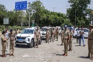Police conduct a flag march in Noida.