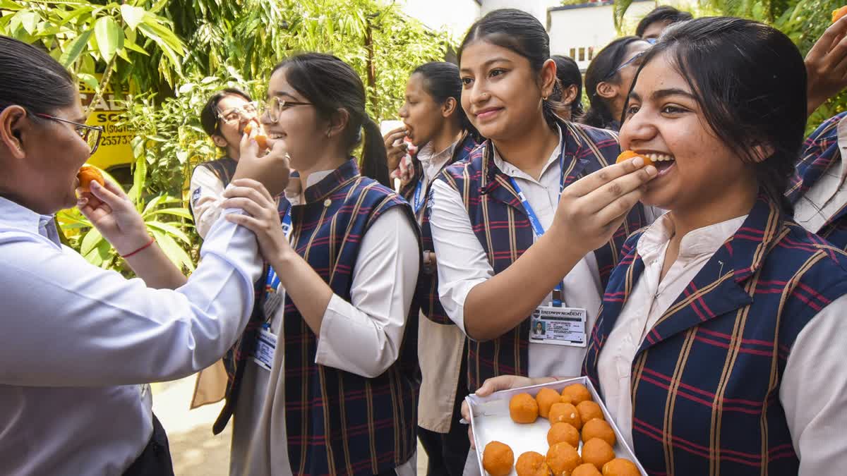 Class 12 students celebrate after CBSE declared the board exam results, in Patna, Tuesday, May 13, 2025.