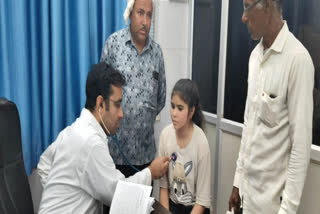 A doctor examining a child at the Madhuhari Center in Kuchaman City