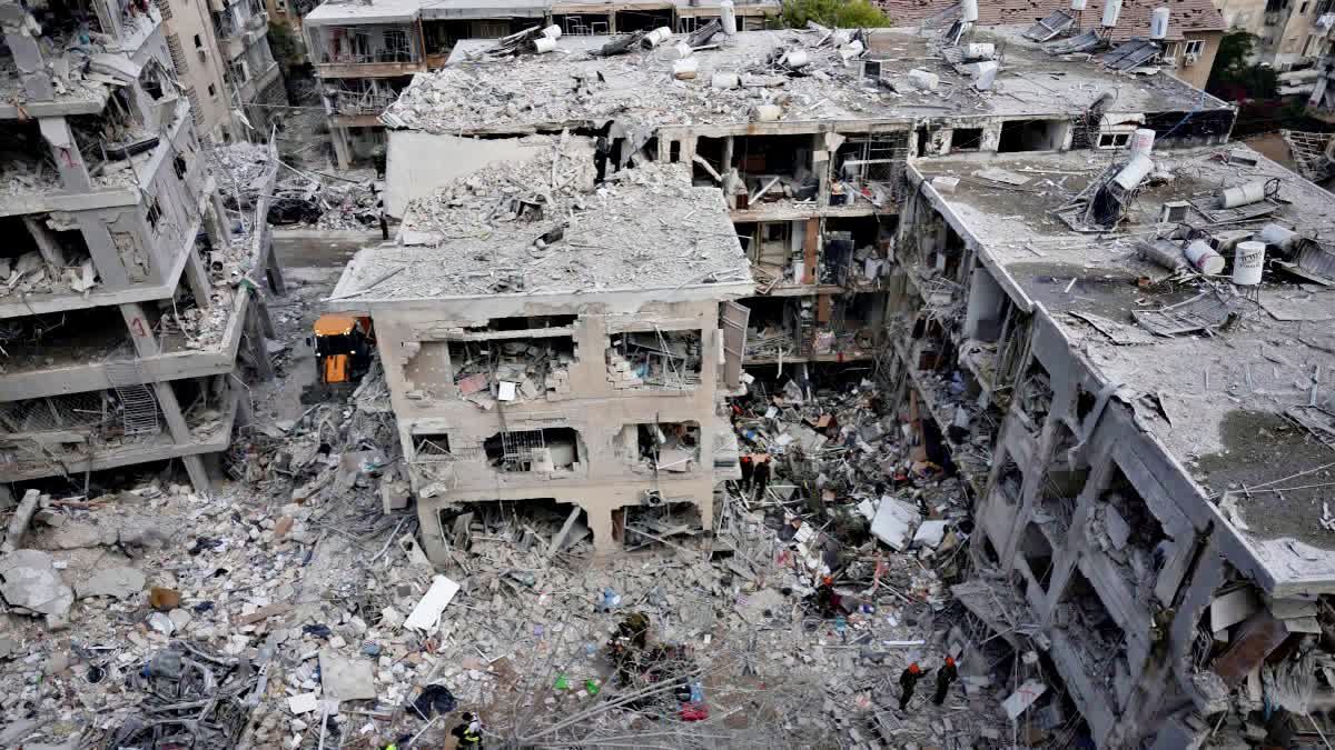 Israeli first responders work in a residential area hit by a missile fired from Iran, near Tel Aviv, Israel, Sunday, June 15, 2025. (AP)