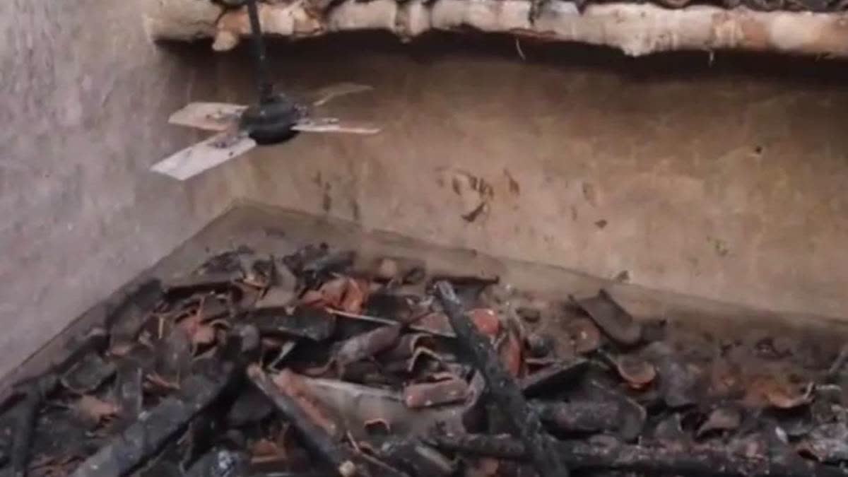 Charred remains of the house where petrol bombs were hurled.