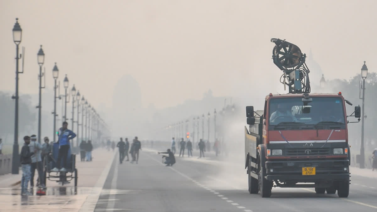 An anti-smog truck sprays mist to settle dust particles as air quality deteriorates, at India Gate, in New Delhi, Thursday, November 13, 2025.