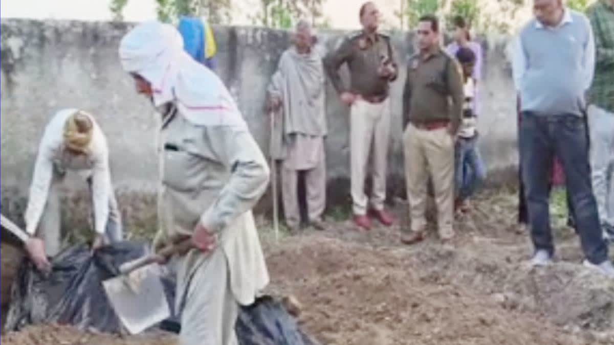Police at the spot where the minor was buried.