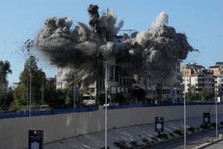 Smoke rises after an Israeli airstrike hits a building near the airport road in Beirut, March 31, 2026.