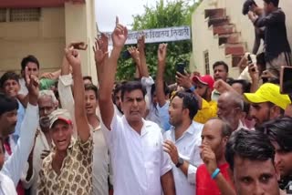 Guardians and villagers protest outside the government senior secondary shool in Liwali.