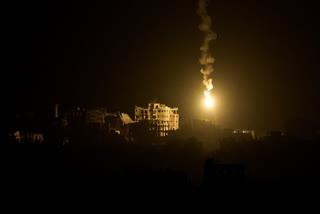 An Israeli army flare drifts over buildings destroyed during the Israeli ground and air operations in the northern Gaza Strip, as seen from southern Israel, Monday, Sept. 15, 2025.