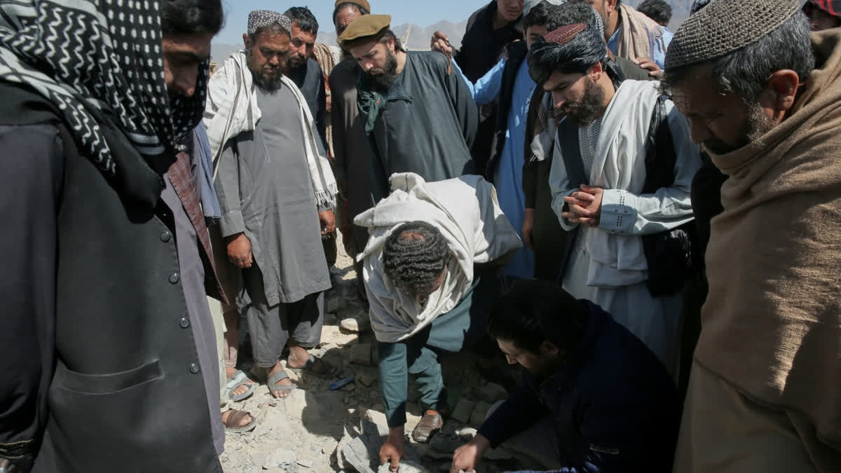 400 Killed, Nearly 250 Injured In Pakistan Strike On Kabul Hospital, Says Afghanistan Residents and Taliban police gather the remains of a projectile at the site of a strike in Kabul, Afghanistan, Friday, March 13, 2026.