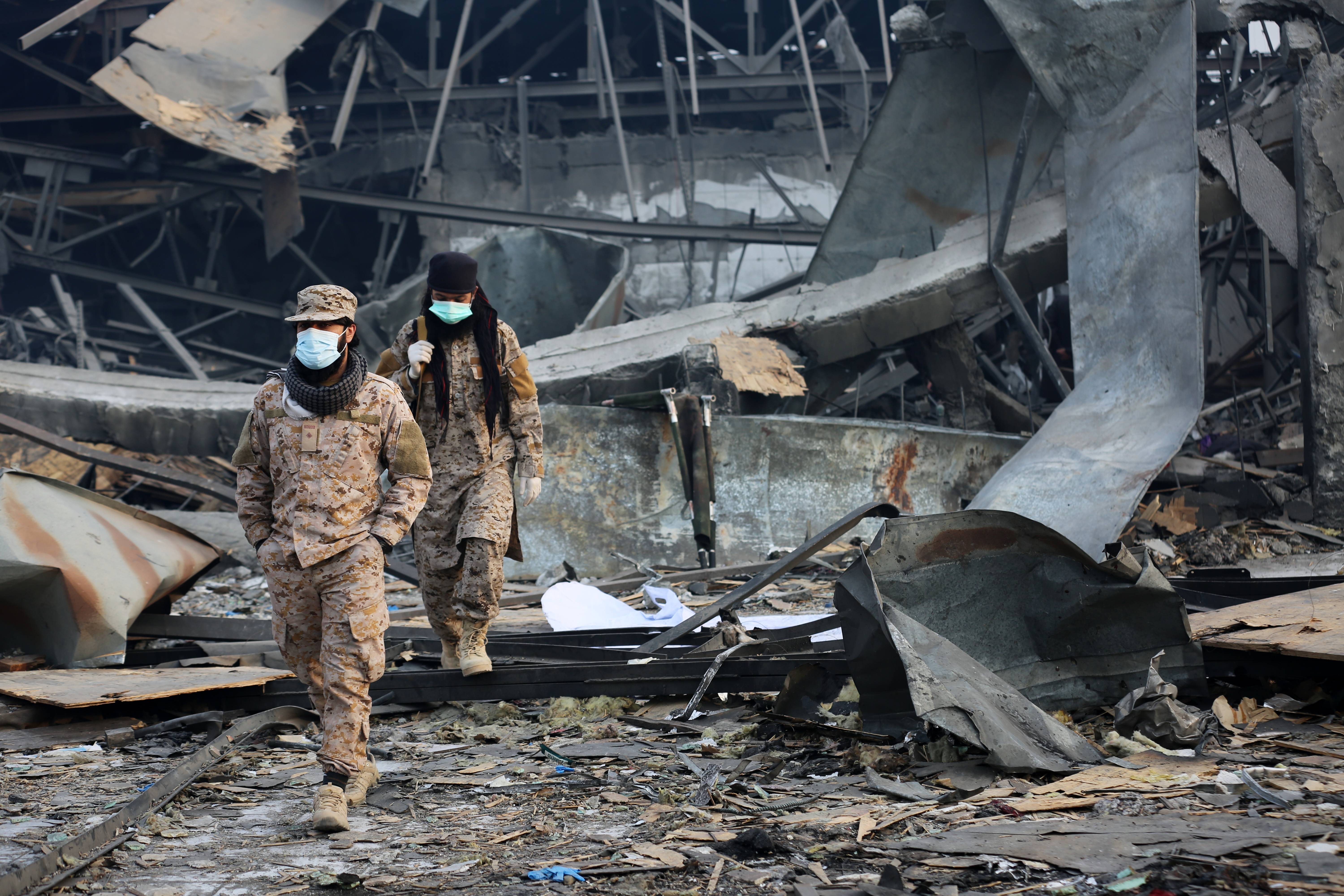 Taliban rescue workers inspect the site of the airstrike at a rehabilitation in Kabul on Tuesday.