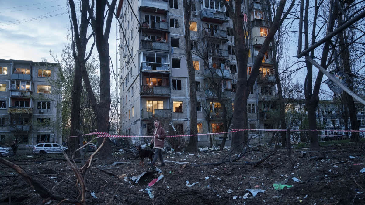 Ukraine Scrambles To Supply Air Defenses As Large-Scale Russia Attacks Kill 16 A woman with a dog walks among the rubble of a house damaged after a Russian strike on residential area in Kyiv, Ukraine, on Thursday, April 16, 2026.