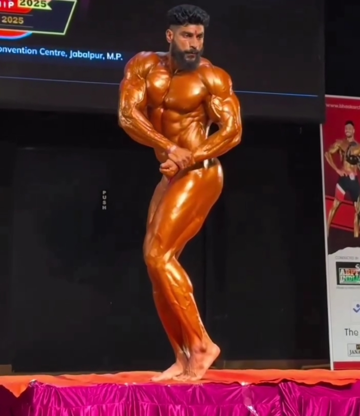 Renowned bodybuilder Sushil Kumar flexes muscles at a bodybuilding competition