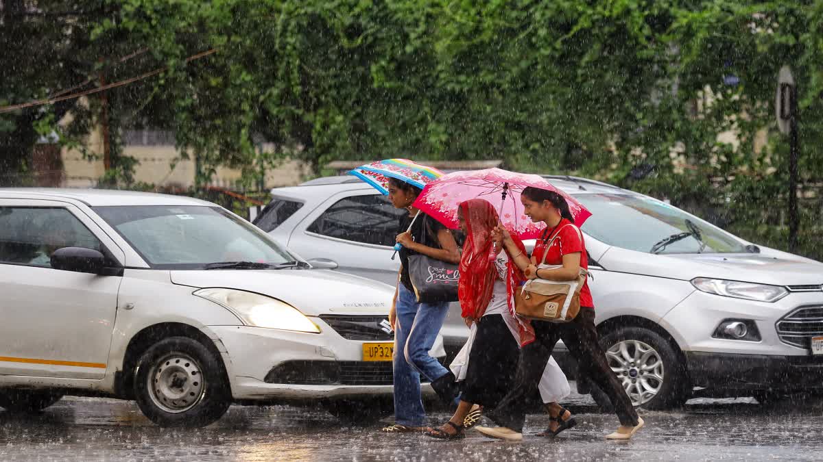 Girls carrying umbrellas to protect themselves from the rain.