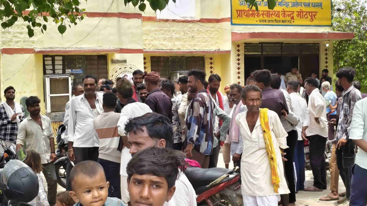 People gather at a  hospital after 30 children fall ill after eating a mid day meal in Devpura Banjara.