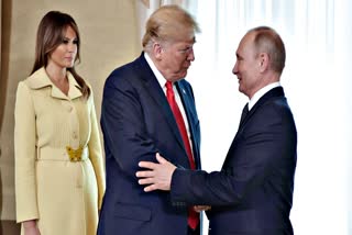 FILE - First lady Melania Trump, left, watches as President Donald Trump and Russian President Vladimir Putin welcome each other