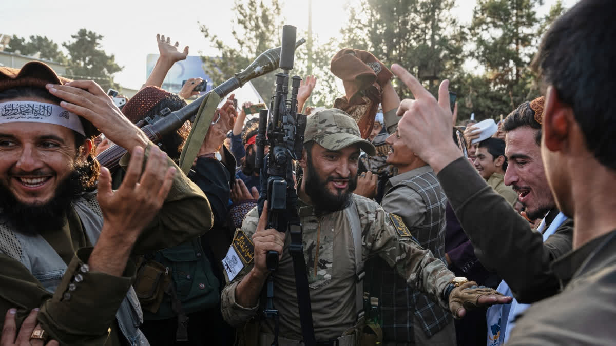 Taliban security personnel dance and cheer during celebrations marking fifth anniversary of the U.S. withdrawal from Afghanistan and the Taliban's return to power, in Afghanistan.